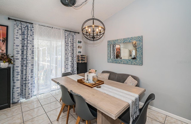 dining space featuring light tile patterned floors, an inviting chandelier, and a textured ceiling