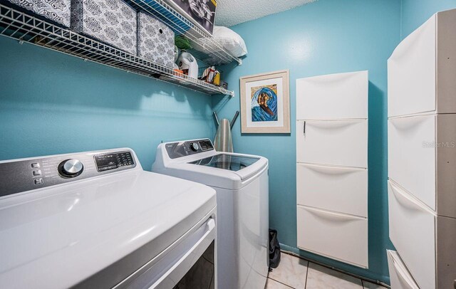 laundry area featuring light tile patterned flooring, laundry area, and washing machine and dryer