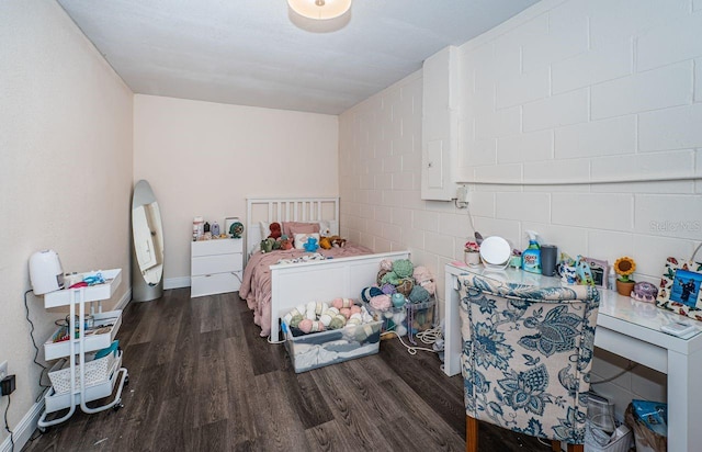 bedroom featuring baseboards and wood finished floors