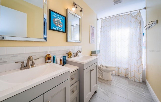 bathroom with decorative backsplash, shower / tub combo, visible vents, toilet, and vanity