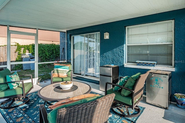 sunroom / solarium featuring an outdoor living space and plenty of natural light