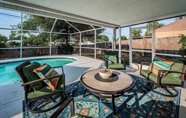 view of pool featuring a fenced in pool, a patio area, glass enclosure, and a fenced backyard