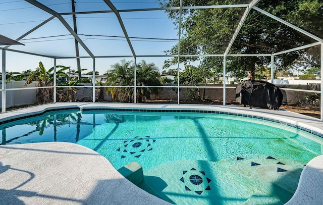 pool featuring a lanai and a fenced backyard