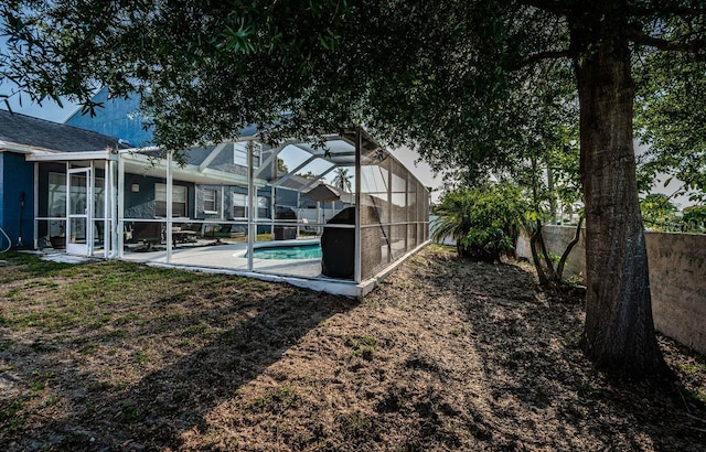 view of yard with a patio, fence private yard, glass enclosure, and an outdoor pool