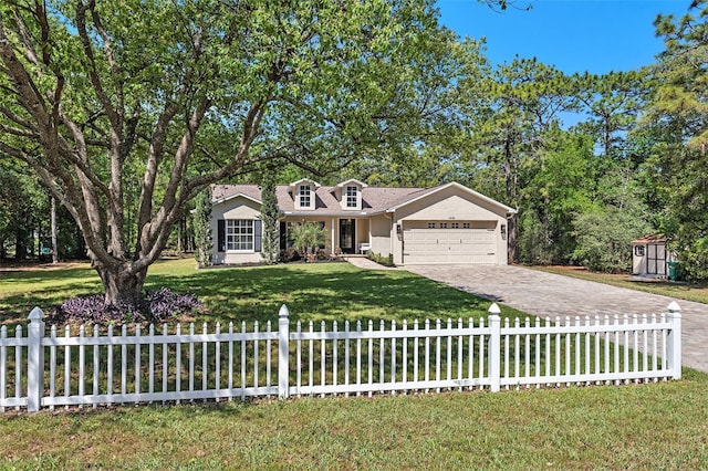 view of front of home with a fenced front yard, driveway, a front yard, and a garage