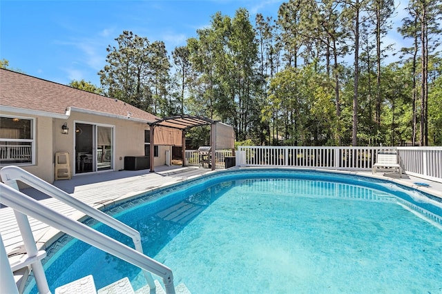 view of swimming pool featuring a pergola, a fenced in pool, and a deck