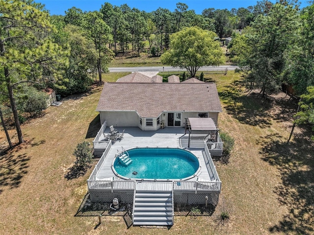 pool featuring a yard and a deck