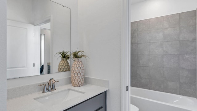 bathroom featuring shower / bathing tub combination, toilet, and vanity