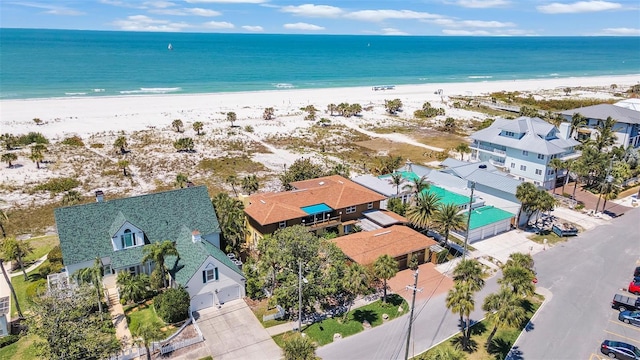 birds eye view of property with a water view and a view of the beach
