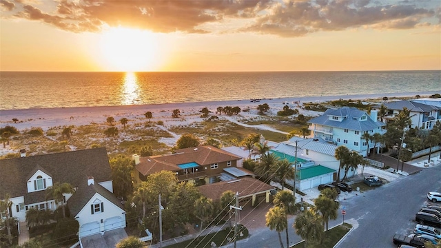 drone / aerial view with a water view and a beach view