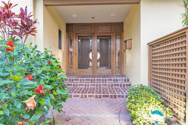 entrance to property with stucco siding and french doors