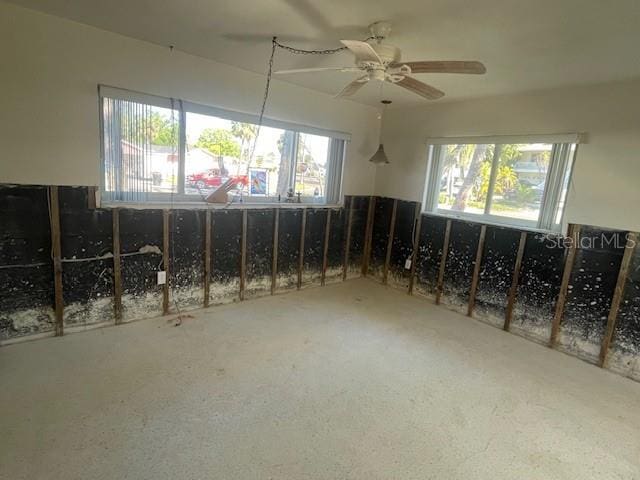 misc room with a ceiling fan and carpet floors