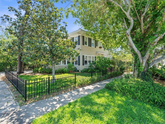 view of front of house with a front lawn and a fenced front yard