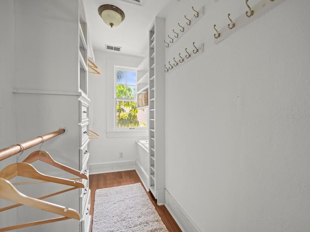 walk in closet with visible vents and dark wood-type flooring