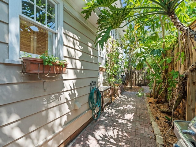 view of side of home featuring a patio and fence
