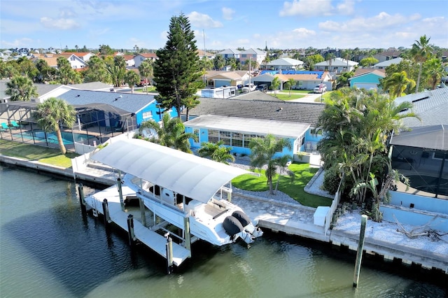 1015 Spindle Palm Way, Apollo Beach, FL 33572 - dock area featuring boat lift, an outdoor pool, a water view, glass enclosure, and a residential view
