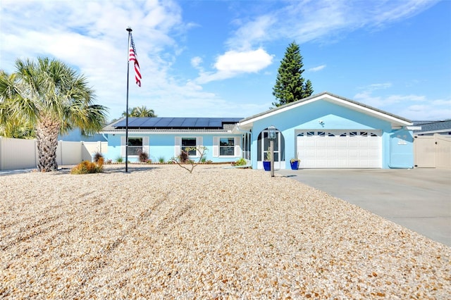 1015 Spindle Palm Way, Apollo Beach, FL 33572 - ranch-style home featuring stucco siding, concrete driveway, fence, and solar panels