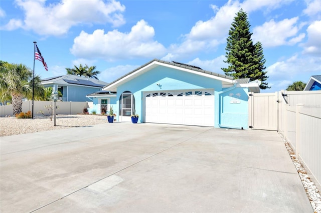 1015 Spindle Palm Way, Apollo Beach, FL 33572 - ranch-style house with a gate, fence, concrete driveway, an attached garage, and stucco siding