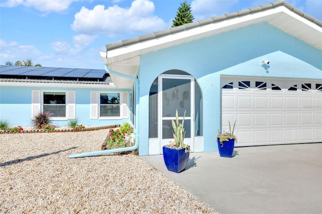 1015 Spindle Palm Way, Apollo Beach, FL 33572 - view of side of home with concrete driveway, roof mounted solar panels, and stucco siding