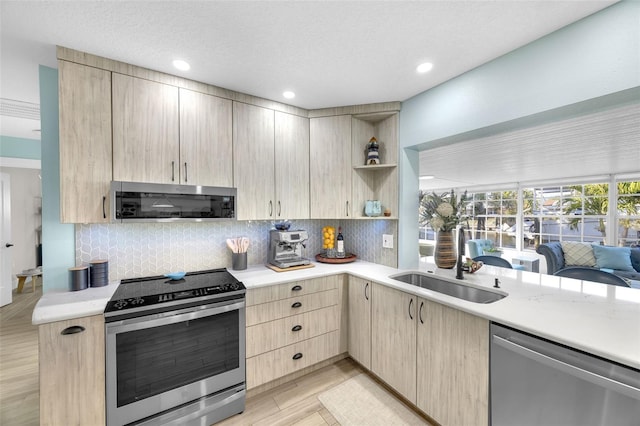 1015 Spindle Palm Way, Apollo Beach, FL 33572 - kitchen featuring open shelves, a sink, light countertops, light brown cabinets, and stainless steel appliances
