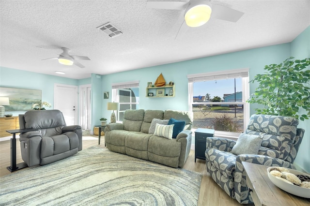 1015 Spindle Palm Way, Apollo Beach, FL 33572 - living area featuring a healthy amount of sunlight, ceiling fan, wood finished floors, and visible vents
