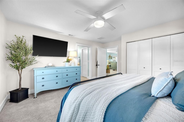 1015 Spindle Palm Way, Apollo Beach, FL 33572 - bedroom with a closet, visible vents, light carpet, baseboards, and a ceiling fan
