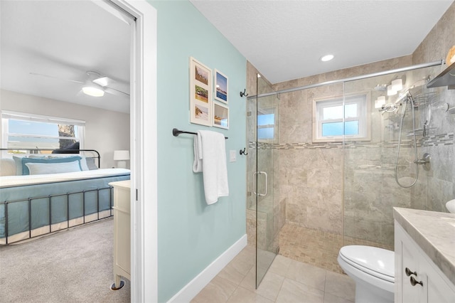 1015 Spindle Palm Way, Apollo Beach, FL 33572 - ensuite bathroom with a ceiling fan, a stall shower, vanity, toilet, and ensuite bathroom