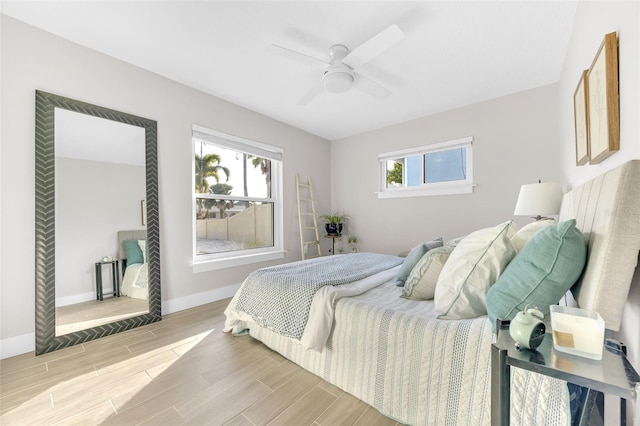 1015 Spindle Palm Way, Apollo Beach, FL 33572 - bedroom with a ceiling fan, baseboards, and light wood-type flooring