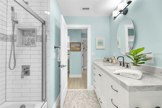 1015 Spindle Palm Way, Apollo Beach, FL 33572 - full bath with tile patterned flooring, vanity, a textured ceiling, shower / bath combination, and visible vents