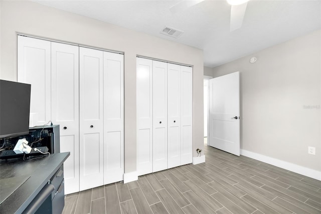 1015 Spindle Palm Way, Apollo Beach, FL 33572 - bedroom featuring visible vents, light wood-style flooring, baseboards, and multiple closets