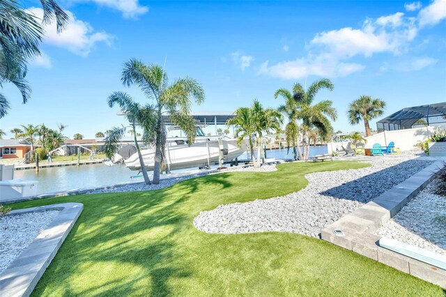 1015 Spindle Palm Way, Apollo Beach, FL 33572 - surrounding community with a lawn, a water view, boat lift, and a dock