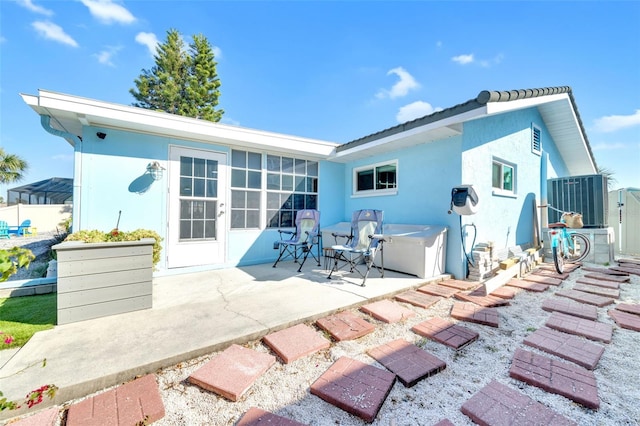 1015 Spindle Palm Way, Apollo Beach, FL 33572 - rear view of house with a patio, central AC, and stucco siding