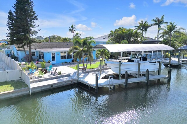1015 Spindle Palm Way, Apollo Beach, FL 33572 - dock area featuring a water view, a patio area, fence, and boat lift