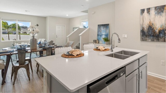 785 Middleton St, Debary, FL 32713 - kitchen with wood tiled floor, plenty of natural light, light countertops, stainless steel dishwasher, and a sink