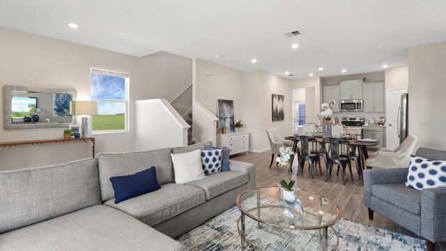785 Middleton St, Debary, FL 32713 - living area featuring recessed lighting, stairway, wood finished floors, visible vents, and baseboards