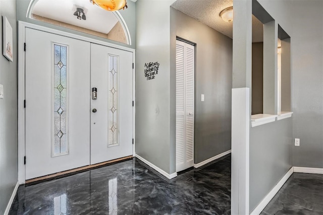 foyer entrance featuring marble finish floor and baseboards