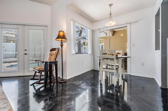 dining space featuring baseboards, a wealth of natural light, and finished concrete floors