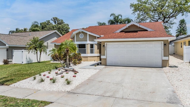 single story home featuring fence, stucco siding, a front yard, and concrete driveway