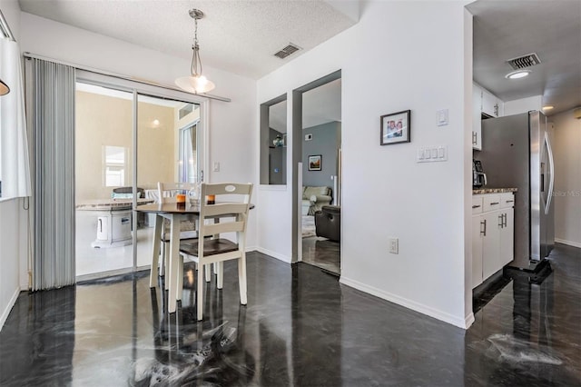 dining area with visible vents, concrete flooring, and baseboards