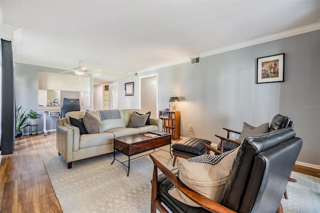 4917 Puritan Cir Unit 105, Tampa, FL 33617 - living area featuring ornamental molding, wood finished floors, ceiling fan, and baseboards