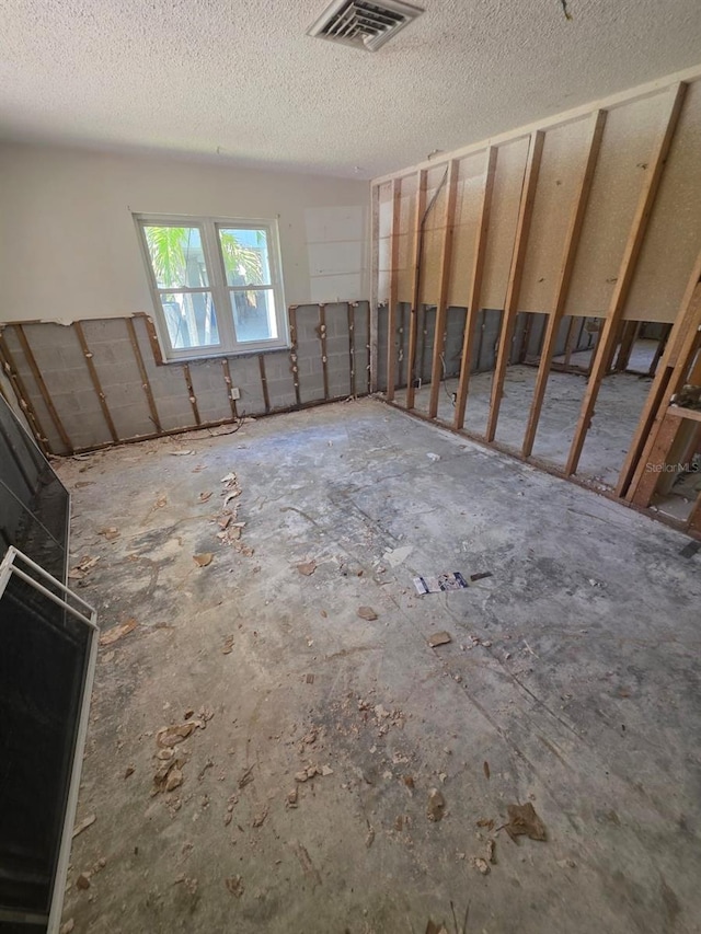 interior space with a textured ceiling and visible vents