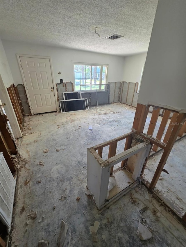 miscellaneous room with a textured ceiling and visible vents