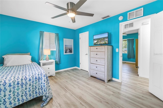 bedroom featuring visible vents, wood finished floors, and baseboards