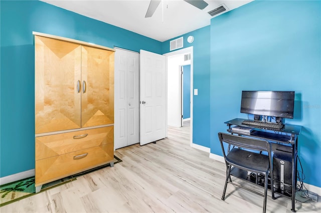 office with baseboards, visible vents, and a ceiling fan