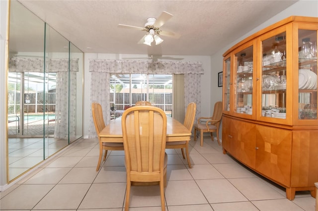 7812 Turnbridge Dr, Port Richey, FL 34668 - dining room featuring ceiling fan, light tile patterned flooring, and a textured ceiling
