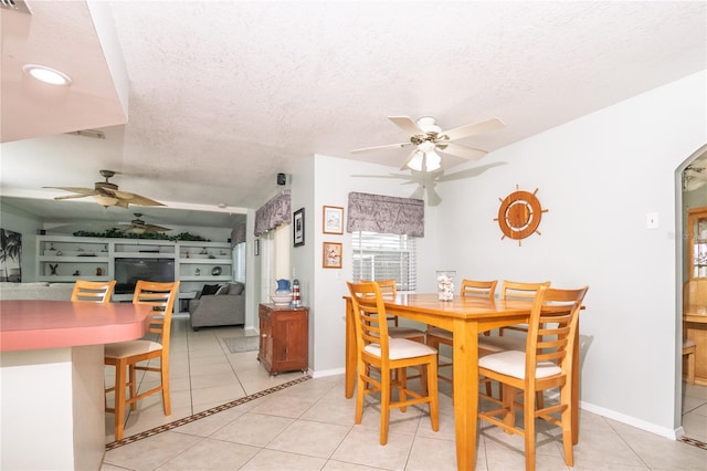 7812 Turnbridge Dr, Port Richey, FL 34668 - dining space featuring ceiling fan, light tile patterned floors, a textured ceiling, and baseboards