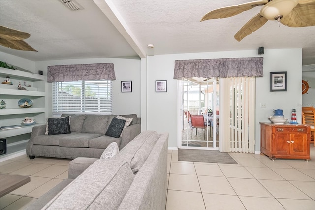 7812 Turnbridge Dr, Port Richey, FL 34668 - living area with ceiling fan, a textured ceiling, light tile patterned floors, and baseboards