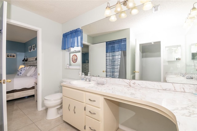 7812 Turnbridge Dr, Port Richey, FL 34668 - ensuite bathroom featuring toilet, tile patterned flooring, a textured ceiling, and vanity