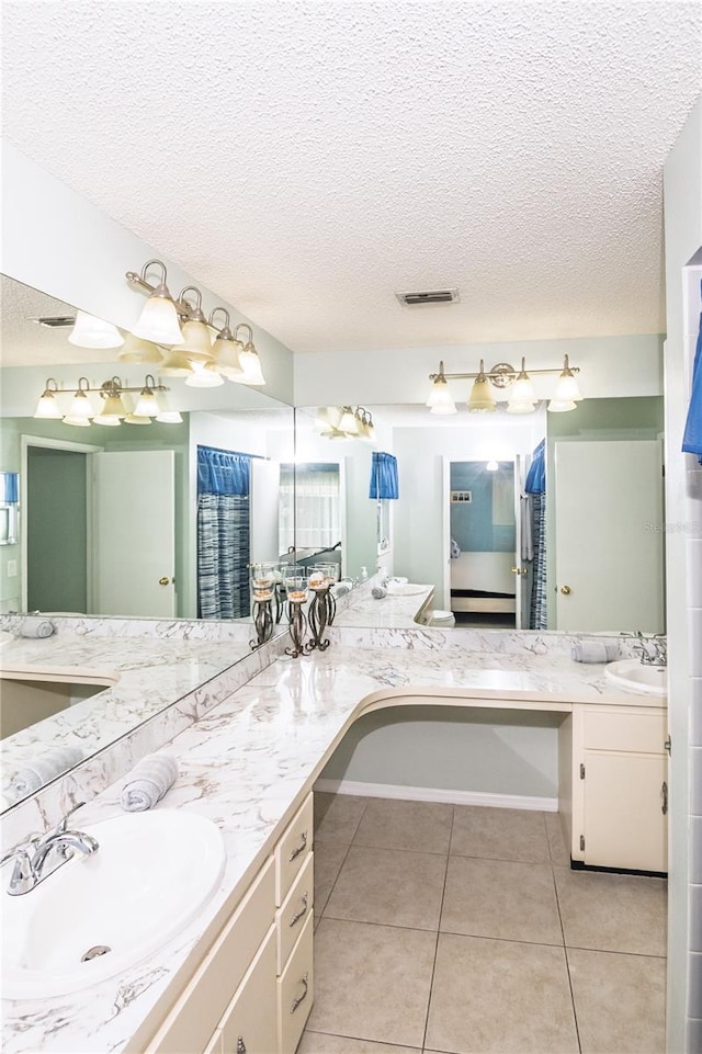 7812 Turnbridge Dr, Port Richey, FL 34668 - bathroom with a textured ceiling, tile patterned floors, and vanity