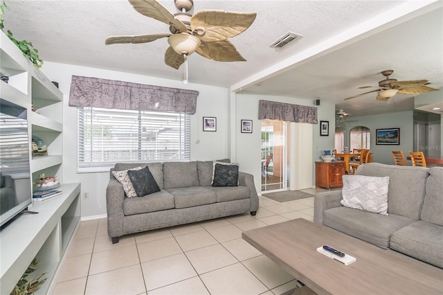 7812 Turnbridge Dr, Port Richey, FL 34668 - living room with a ceiling fan, light tile patterned floors, and a textured ceiling